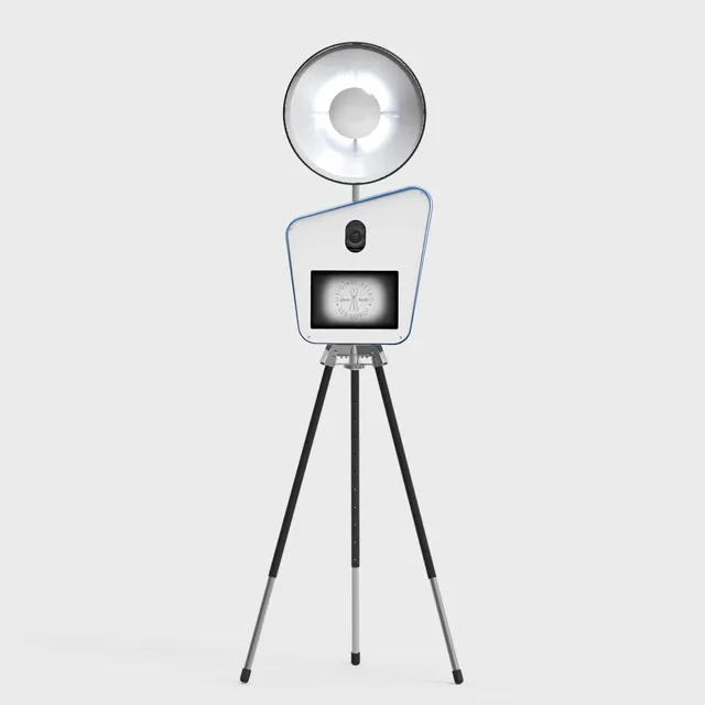 Retro photo booth on a tripod with a large dish ring light and a camera above a small screen.